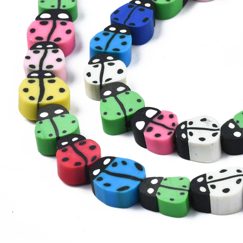 zoomed in sections multicolor polymer clay ladybug bead strands over white background. 
