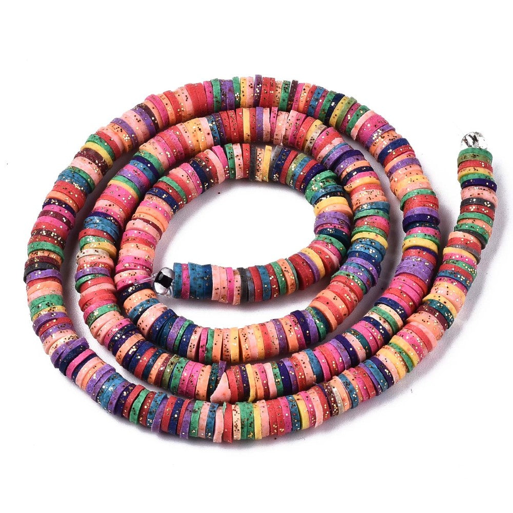gold glitter coated multicolor polymer clay disc bead strand in a swirl design over white surface. 
