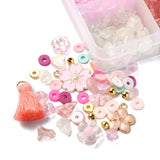 corner of pretty in pink bead box with a collection of beads showing the variety contained within the kit over white background. 