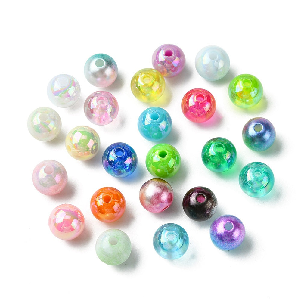 cluster of loose examples of each of the twenty-four varieties of beads over white background. 