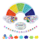 rainbow shaped bead box containing five colors of seed beads along with multicolor discs letter and heart symbol beads with a spool of crystal string and some examples of the loose beads below all over white background. 