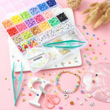 twenty six compartment plastic bead storage bin with eighteen different color Heishi beads as well as an array of colorful letters and symbols plus small bags of golden charms a spool of cord and a pair of scissors and tweezers over pink surface with some samples of the beads and a finished bracelet displayed. 