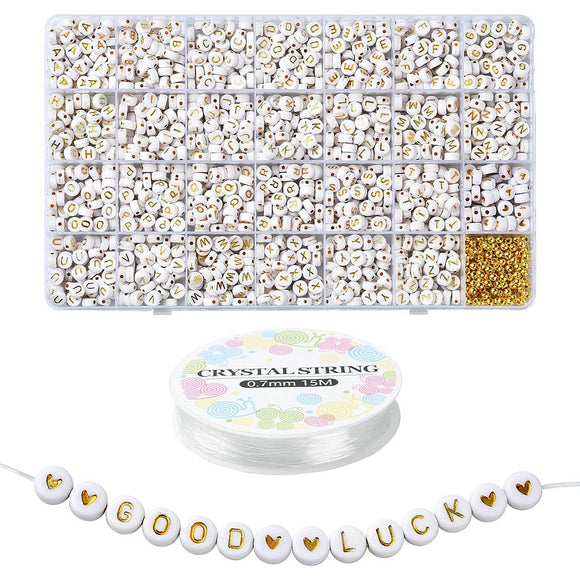 twenty-eight compartment bead box filled with gold lettered round flat white beads and gold spacer beads with a spool of crystal spring cord below and a sample of strung beads showing heart and letter beads that spell out good luck over white background. 