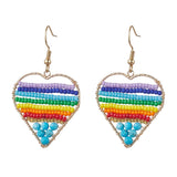 silver tone multicolor dyed magnesite and glass seed bead rainbow heart earrings with ear wires over white background. 