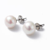 silver tone and white pearl studs over white background. 
