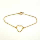golden cable chain bracelet with center heart focal and lobster claw clasp on white background. 