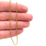 stainless steel cable chain displayed on a hand with white background. 