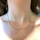 stainless steel cable chain displayed on a human neck.