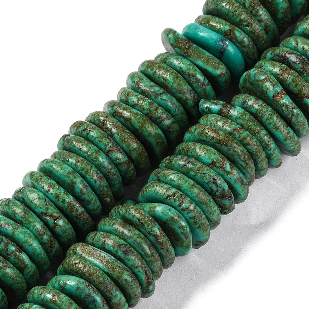 close-up of coconut dark green, synthetic turquoise graduated bead strands over white surface. 