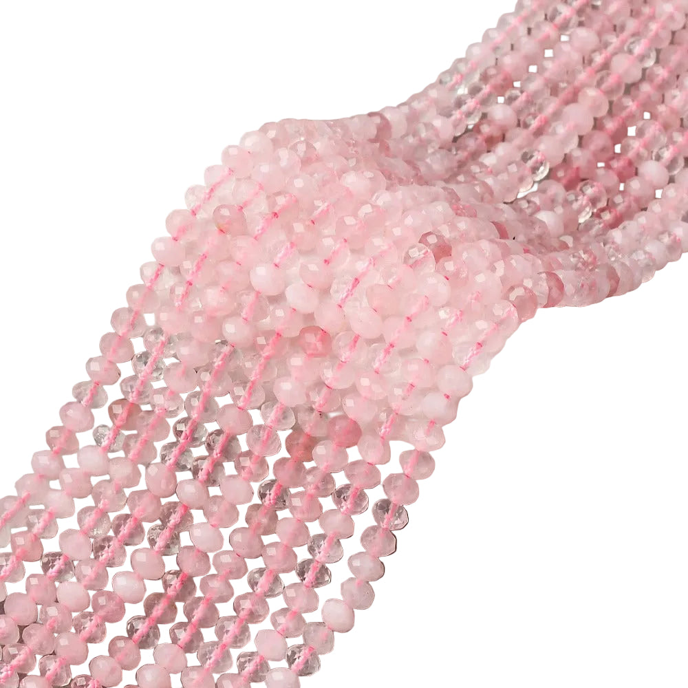 faceted rondelle rose quartz bead strands over white background.