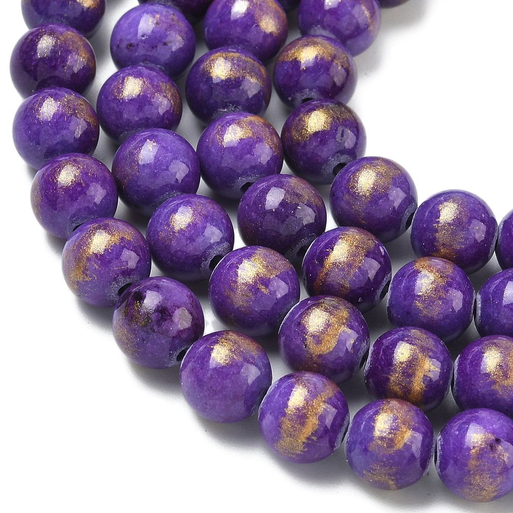 zoomed in sections of smooth round and dyed purple jade bead strands with gold foil over a white surface. 