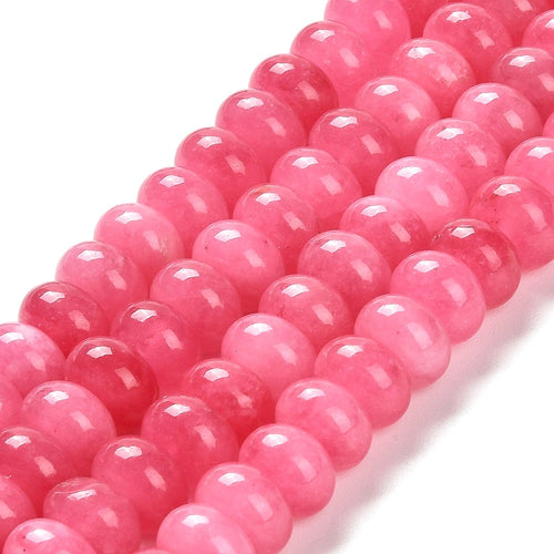 zoomed in sections of pink dyed jade rondelle strands over white surface. 