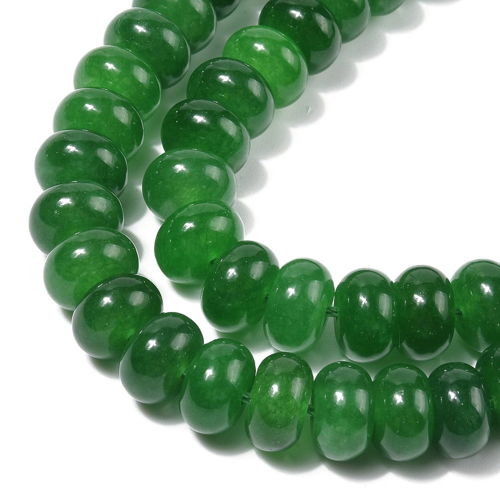 zoomed in section of dark green dyed jade rondelle strand over white 