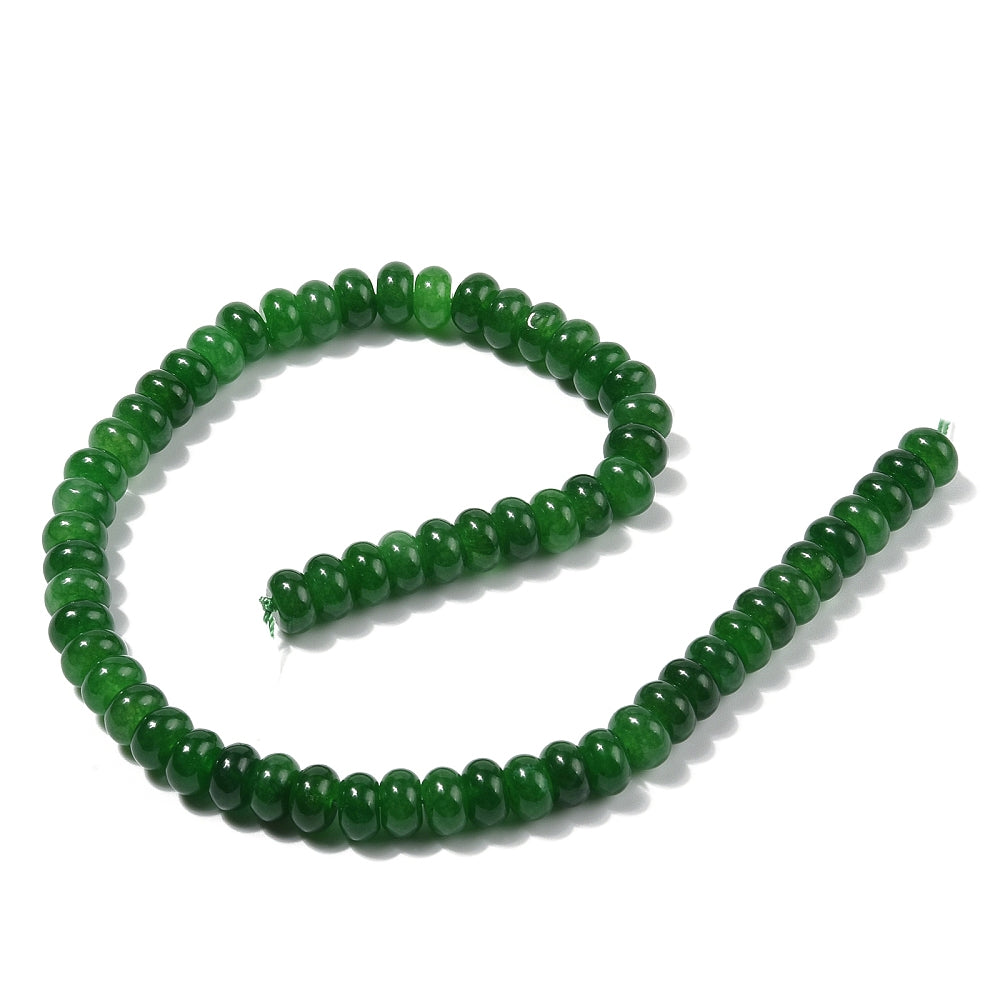 dark green dyed jade rondelle strand in swirl display over white surface. 