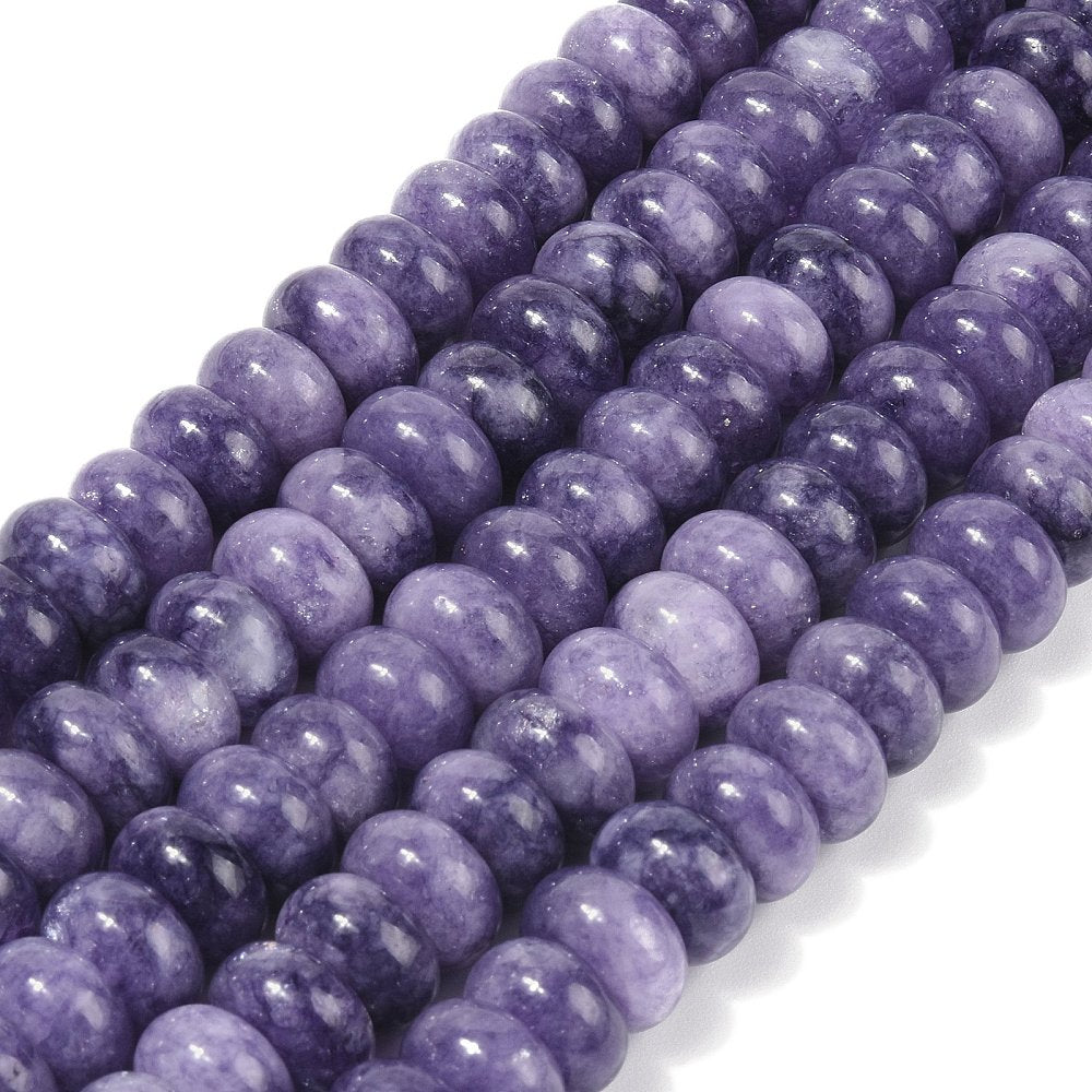 zoomed in sections of light purple dyed jade rondelle strands over white surface. 