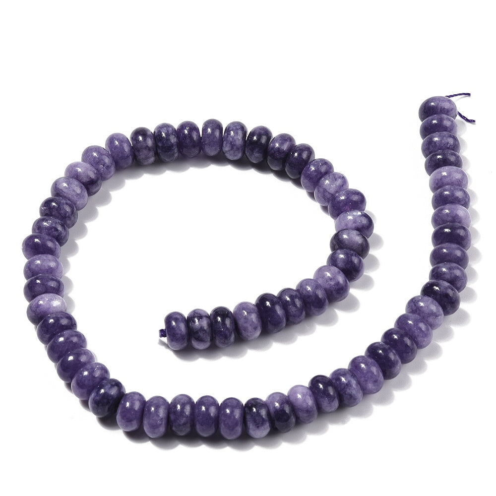 light purple dyed jade rondelle strand in swirl display over white surface. 