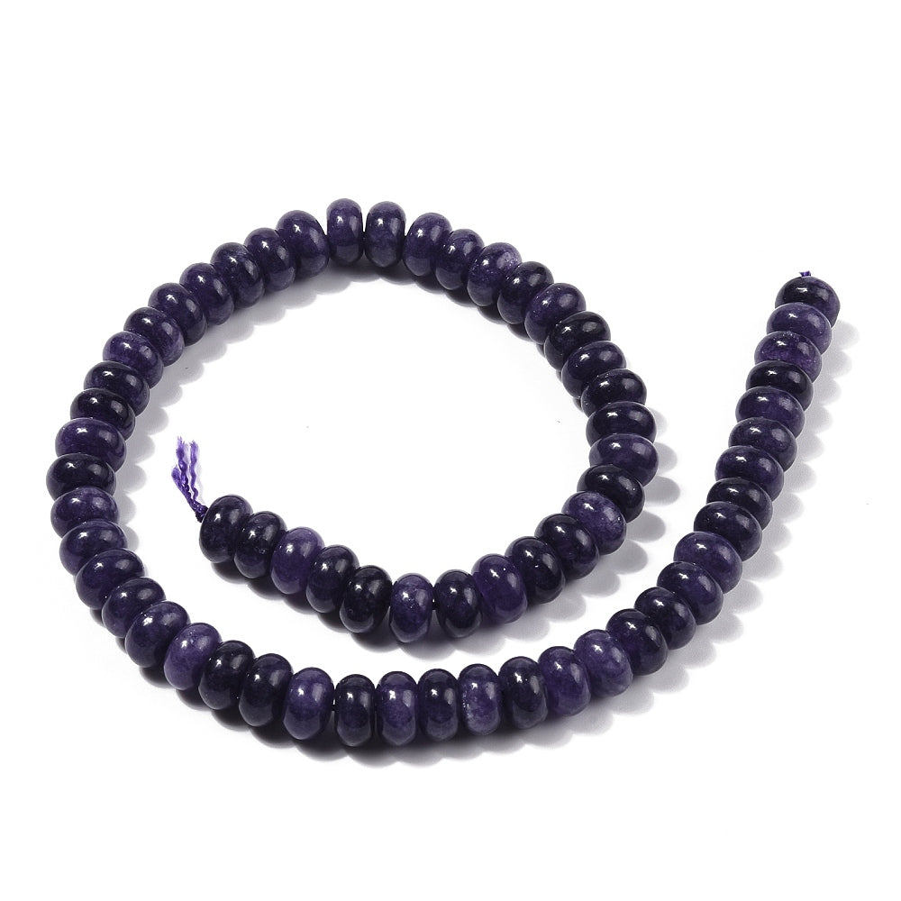 dark purple dyed jade rondelle strand in swirl display over white surface. 