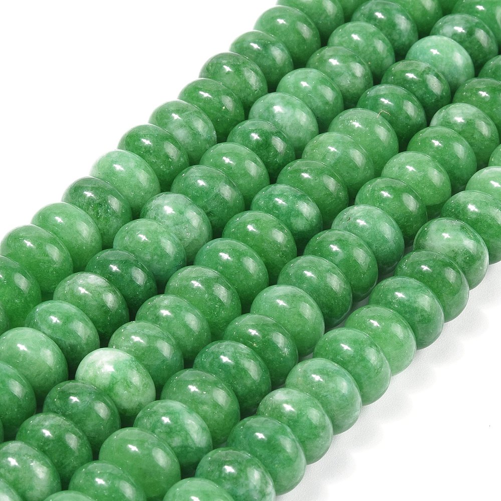zoomed in sections of green dyed jade rondelle strands over white surface. 