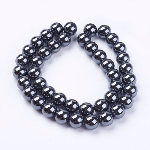 round hematite bead strand over white surface. 