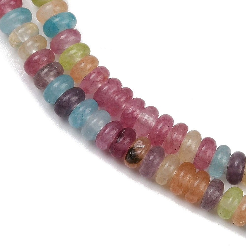 zoomed in sections of multicolor dyed jade smooth rondelle bead strand over white surface. 