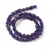 purple skull carved stone bead strand over white background. 