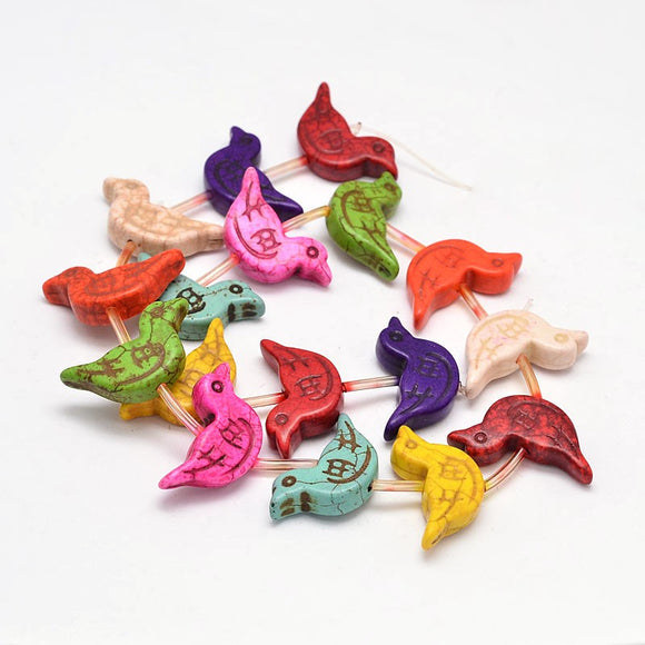 multicolor magnesite bird bead strand over white background. 