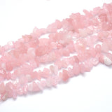six tumbled rose quartz large chip strands over white background. 