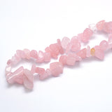 zoomed in section of tumbled rose quartz large chip strands over white background. 