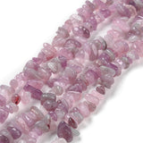 multiple darker rose quartz chip strands over white background. 