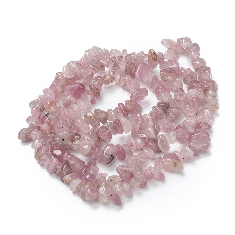 darker rose quartz chip strand in a swirl design over white background. 