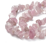 zoomed in sections of darker rose quartz chip strands over white background. 