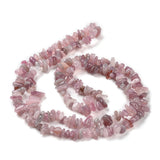 darker rose quartz chip strand in a swirl design over white background. 