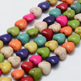 five strands of multicolor dyed magnesite heart stone beads over white background. 