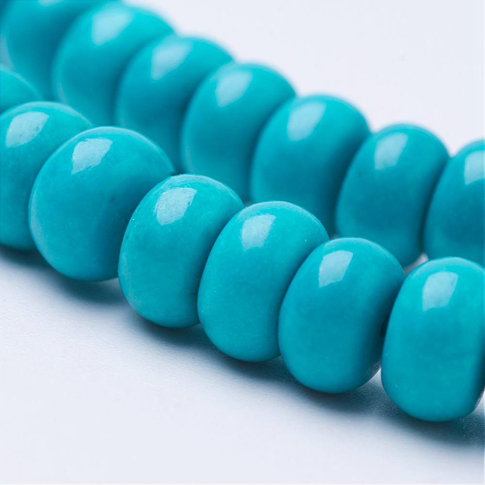 zoomed in sections of two dyed turquoise magnesite rondelle bead strands over white background. 