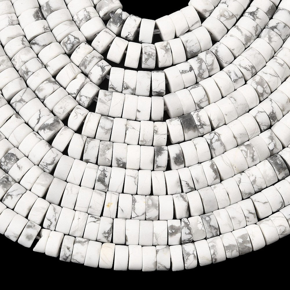 ten natural Howlite Heishi bead strands over black surface. 