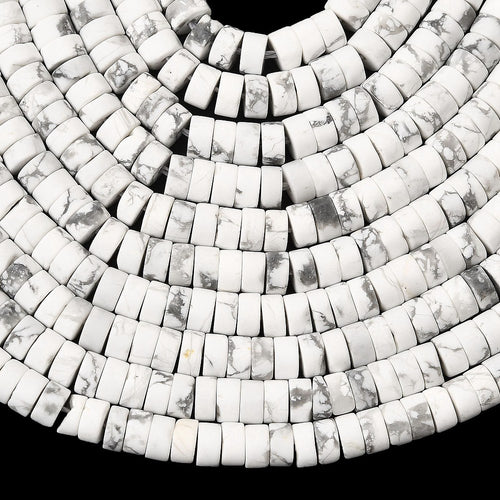 ten natural Howlite Heishi bead strands over black surface. 