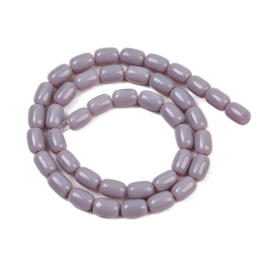 lavender glass barrel bead strand in swirl design over white surface. 