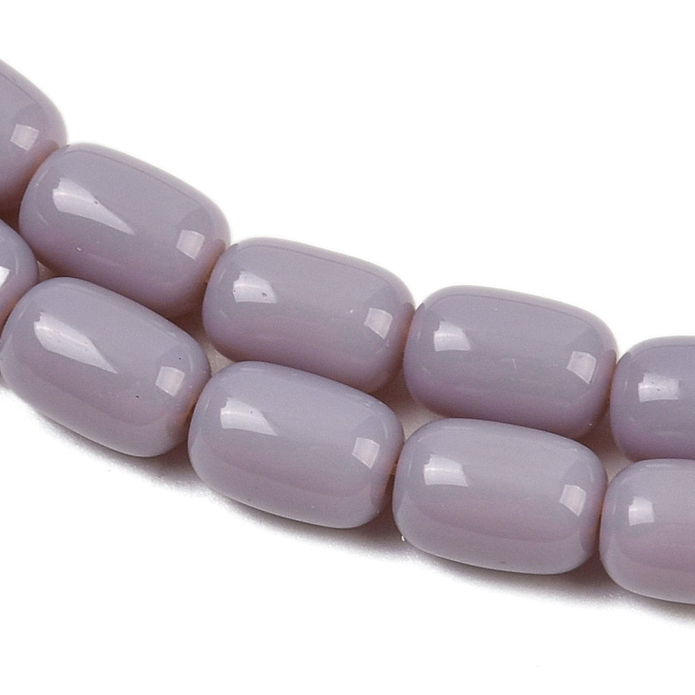 zoomed in sections of lavender barrel bead strands over white surface.