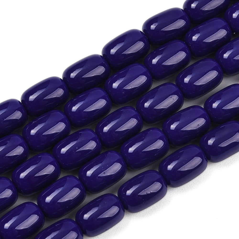 zoomed in sections of dark blue barrel bead strands over white surface.