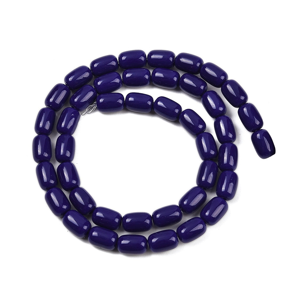 dark blue glass barrel bead strand in swirl design over white surface. 