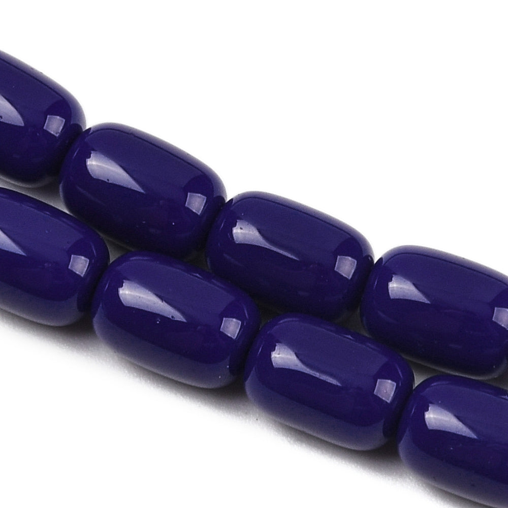zoomed in sections of dark blue barrel bead strands over white surface.