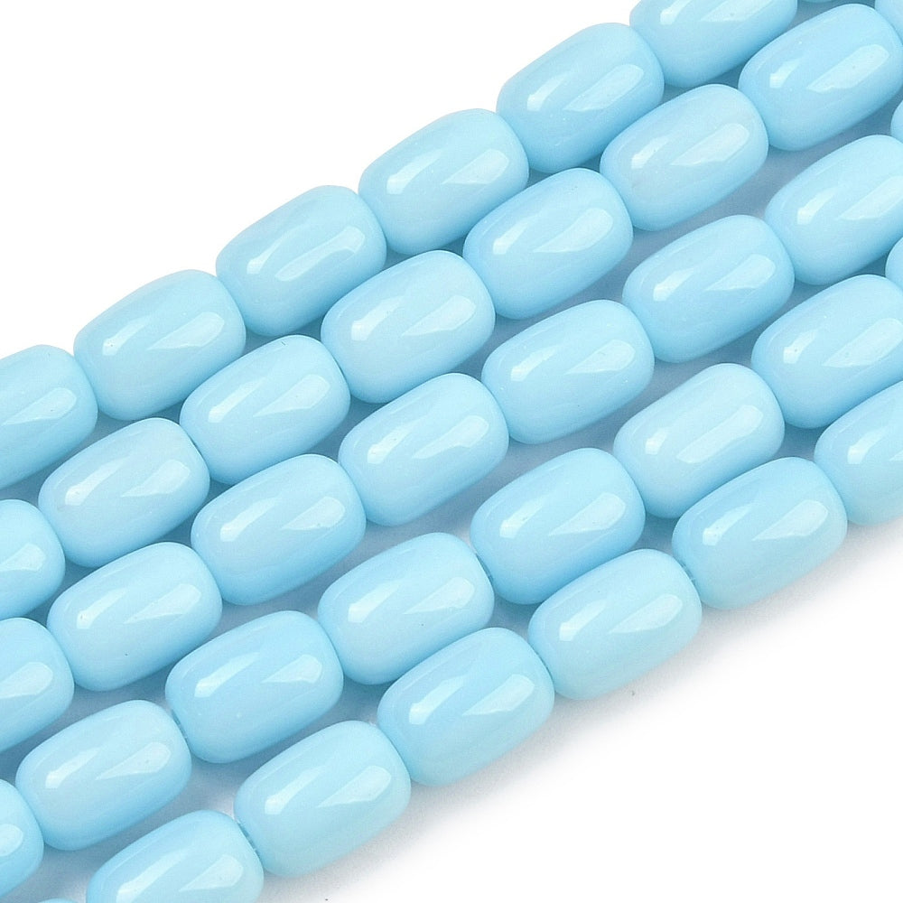 zoomed in sections of sky blue barrel bead strands over white surface.