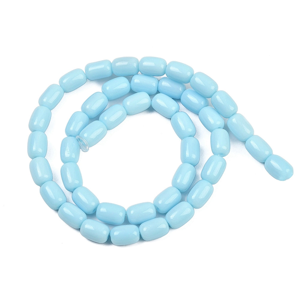 sky blue glass barrel bead strand in swirl design over white surface. 