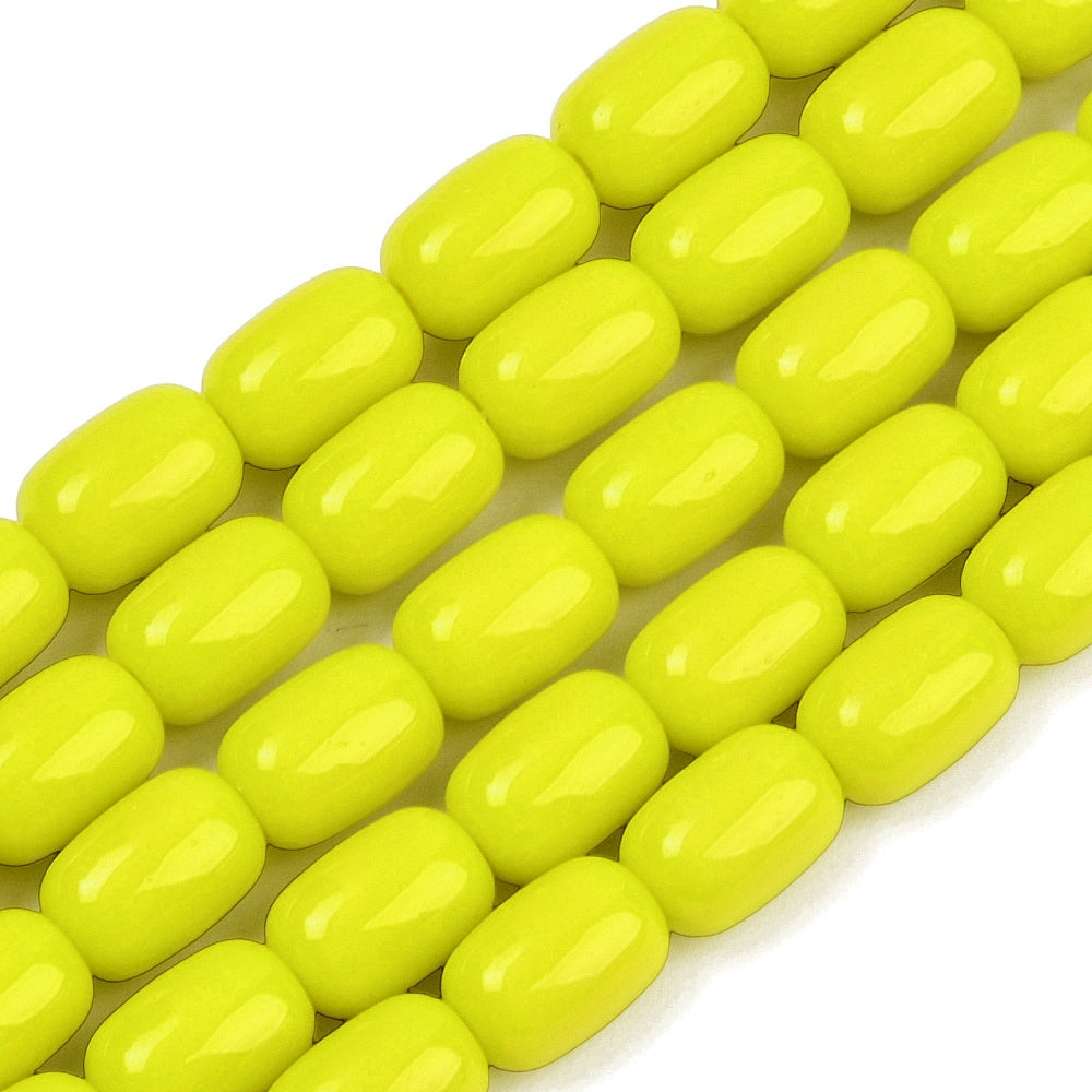 zoomed in sections of yellow barrel bead strands over white surface.
