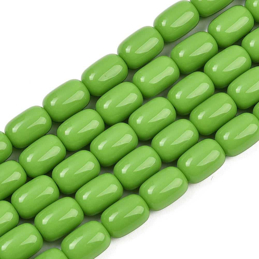 zoomed in sections of lime green barrel bead strands over white surface.