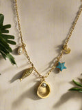 small gold link chain charm necklace with a pearl drop, gold fish, gold oyster with pearl, blue starfish and gold anchor charms