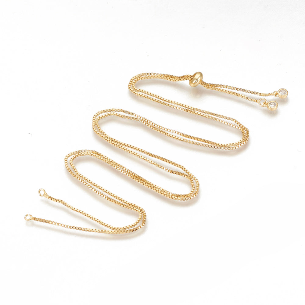 golden adjustable box chain slider necklace with gold slider bead and bezel set clear stone stoppers 