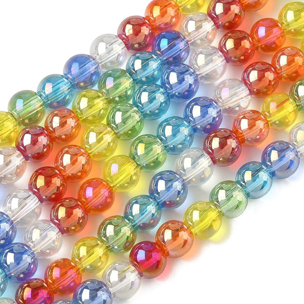 zoomed in sections of iridescent transparent rainbow glass bead strands over white surface. 
