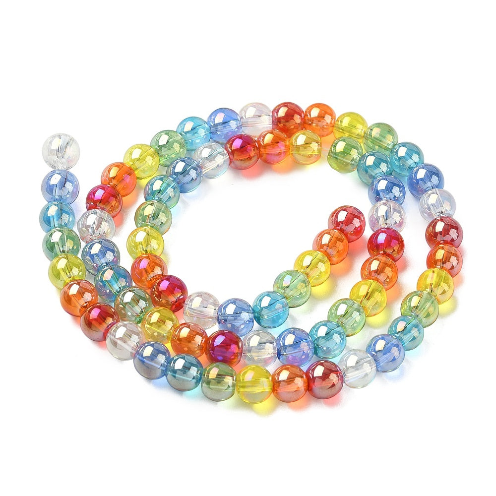 iridescent transparent rainbow glass bead strand in swirl design over white surface.
