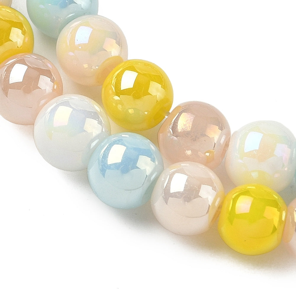 zoomed in sections of iridescent opaque blue and yellow glass bead strand over white surface. 